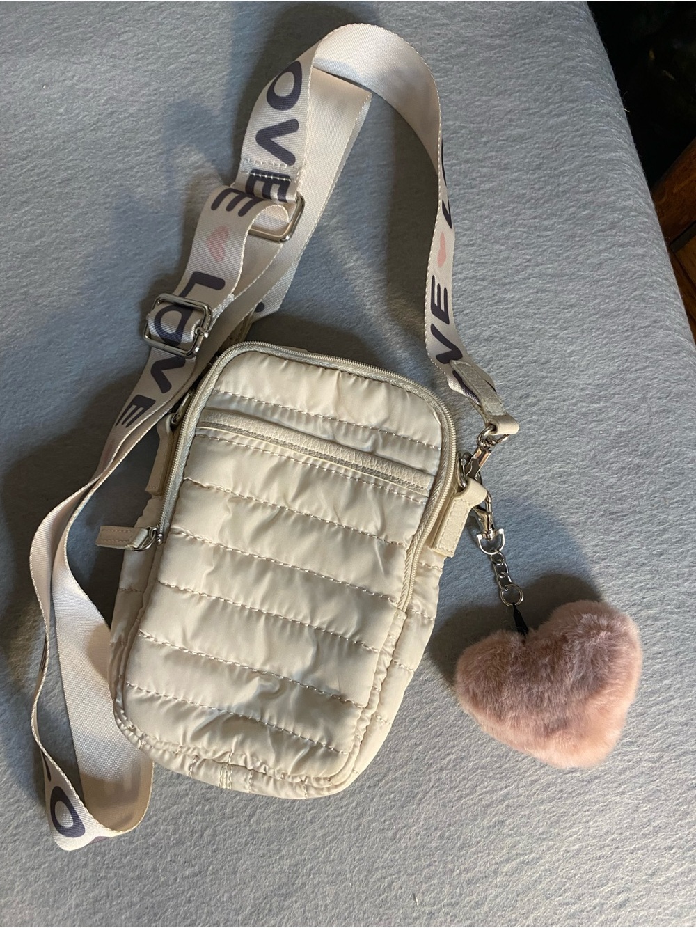 Cream Quilted Crossbody Bag with Pink Heart Charm and Branded Strap